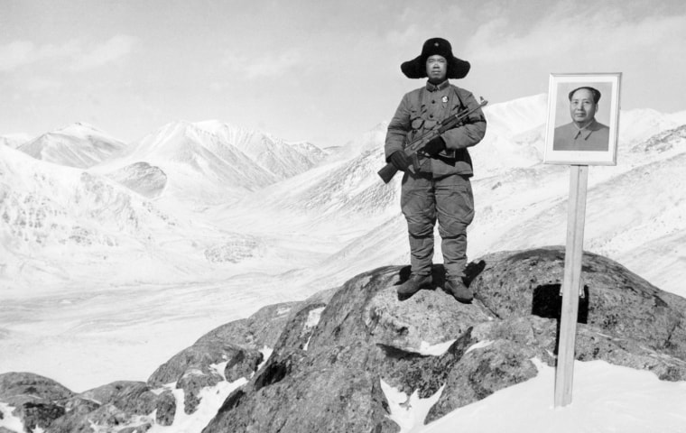 Image: Chinese soldier poses next to a portrait of Mao Zedong in April 1969 on the Soviet-Afghan border in the Xinjiang region