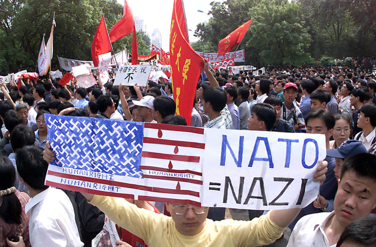 A protestor holds up a makeshift American flag in Beijing