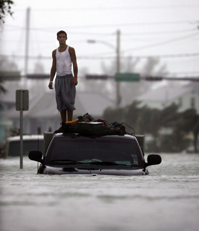 Key West resident stands on the roof of his truck after Hurricane Wilma hits Florida's southern west coast