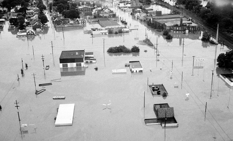 This aerial view shows houses submerged in floodwater in the aftermath of tropical storm Agnes in downtown Pottstown, Pa., June 23, 1972.  (AP Photo)
