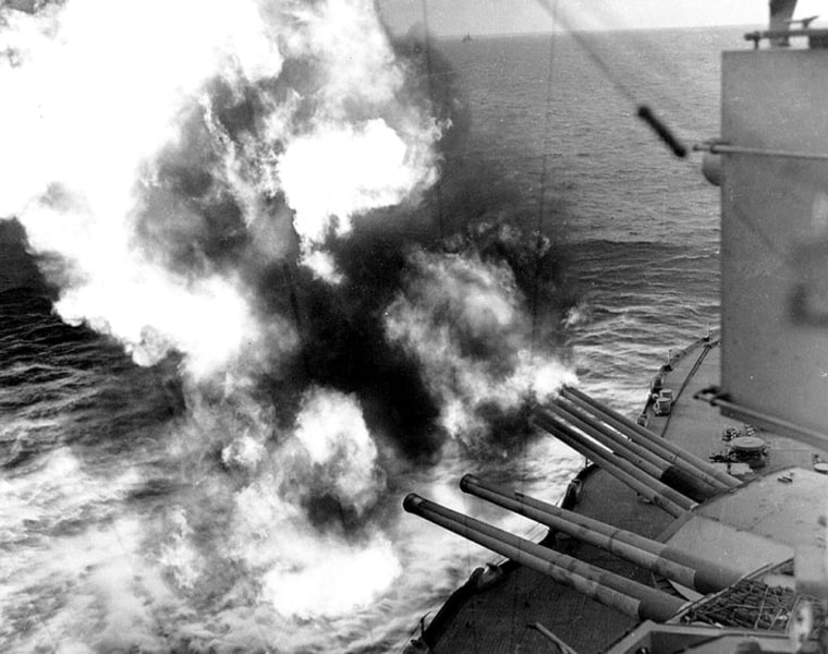 Forward 14\"/45 guns of USS Nevada (BB-36) fire on positions ashore, during the landings on \"Utah\" Beach, 6 June 1944.