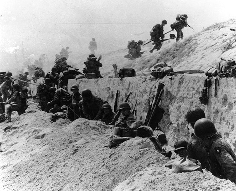 Troops move over the Utah Beach seawall, June 1944.