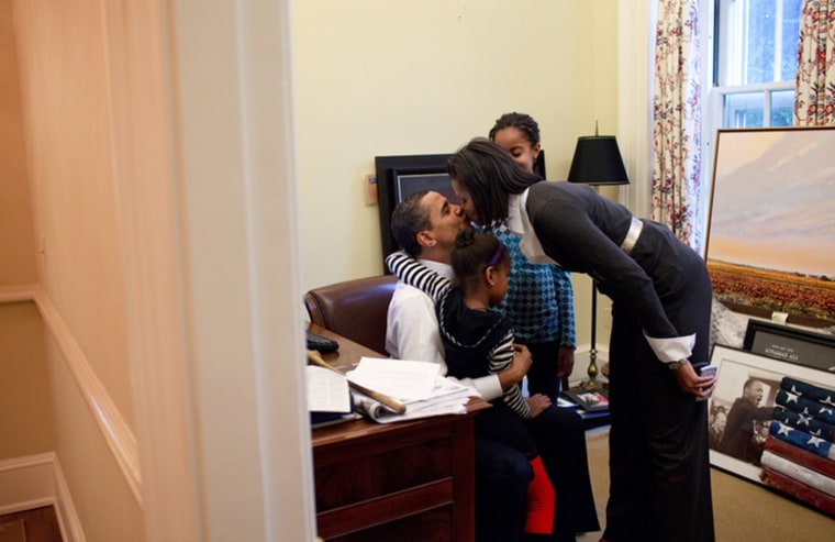 President Barack Obama visits with his daughters Malia and Sasha and kisses his wife, First Lady Michelle Obama, in a private study off the Oval Office 2/2/09
Official White House Photo by Pete Souza