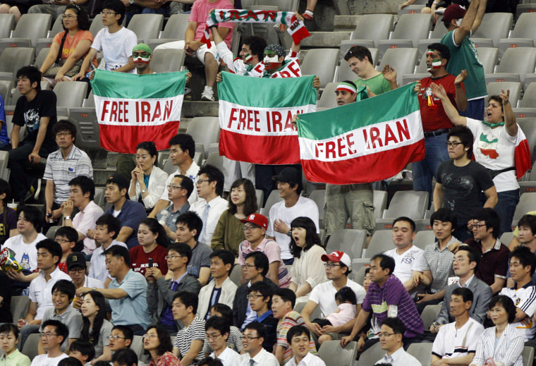 Image: Iranian soccer fans hold signs during 2010 World Cup qualifying soccer match between Iran and South Korea in Seoul