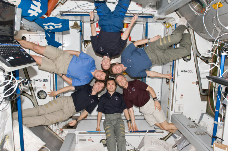 ISS020-E-008898 (14 June 2009) --- The six-person Expedition 20 crew poses in \"star-burst\" formation for an in-flight portrait in the Harmony node of the International Space Station. Pictured clockwise from right (center) are cosmonaut Gennady Padalka, commander; Canadian Space Agency astronaut Robert Thirsk, Japan Aerospace Exploration Agency (JAXA) astronaut Koichi Wakata, NASA astronaut Michael Barratt, cosmonaut Roman Romanenko and European Space Agency astronaut Frank De Winne, all flight engineers.