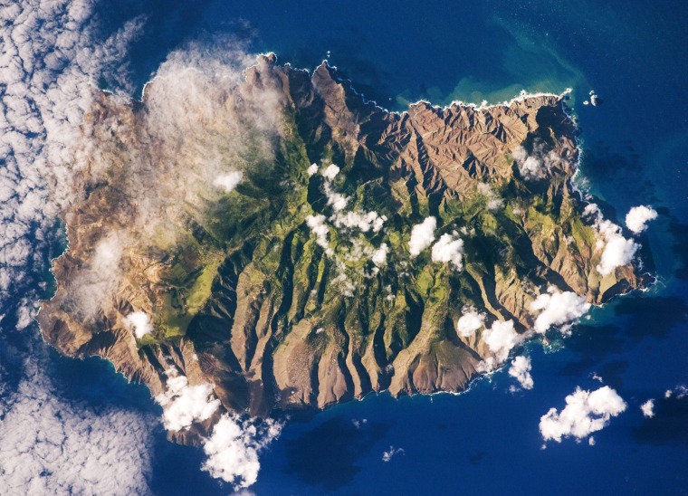 Saint Helena Island, located in the South Atlantic Ocean approximately 1,860 kilometers (1,156 miles) west of Africa, was one of the many isolated islands that naturalist Charles Darwin visited during his scientific voyages in the nineteenth century. He visited the island in 1836 aboard the HMS Beagle, recording observations of the plants, animals, and geology that would shape his theory of evolution. This image was acquired by astronauts onboard the International Space Station as part of an ongoing effort (the HMS Beagle Project <http://www.thebeagleproject.com/index.html> to document current biodiversity in areas visited by Charles Darwin.
This astronaut photograph shows the islandÕs sharp peaks and deep ravines; the rugged topography results from erosion of the volcanic rocks that make up the island. The change in elevation from the coast to the interior creates a climate gradient. The higher, wetter center is covered with green vegetation, whereas the lower coastal areas are drier and hotter, wit