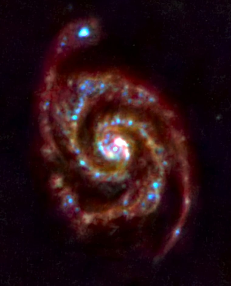 Three-colour far-infrared image of M51, the Ôwhirlpool galaxyÕ. 

Red, green and blue correspond to the 160-micron, 100-micron and 70-micron wavelength bands of the HerschelÕs Photoconductor Array Camera and Spectrometer, PACS. 

Glowing light from clouds of dust and gas around and between the stars is visible clearly. These clouds are a reservoir of raw material for ongoing star formation in this galaxy. Blue indicates regions of warm dust that is heated by young stars, while the colder dust shows up in red.