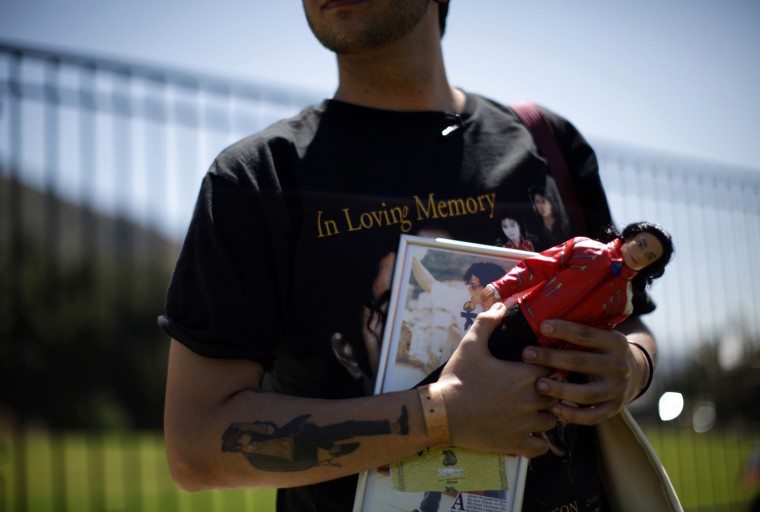 Image: Michael Jackson fan Leandro Lapagesse of Brazil holds memorabilia outside of the Forest Lawn Mortuary in Los Angeles