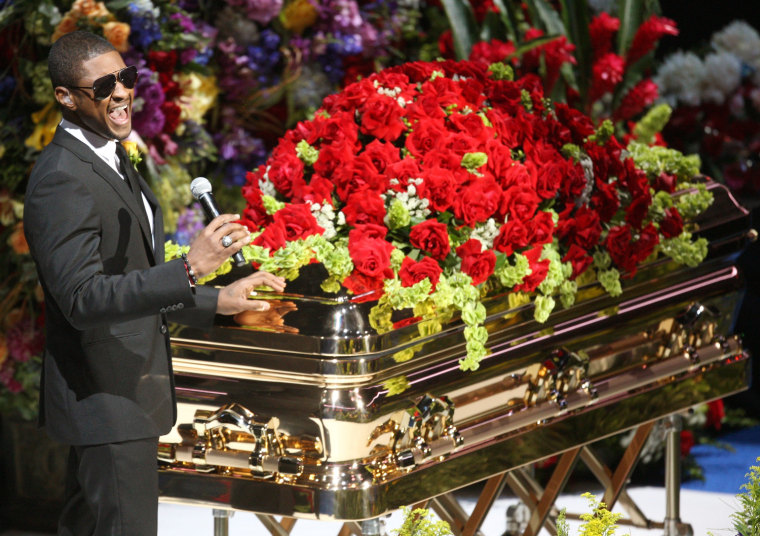 Usher performs at the casket during the memorial service for the late pop s...