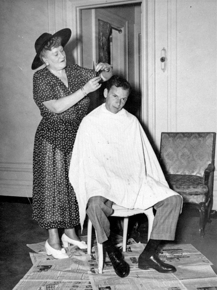Frank Sinatra,  gets a haircut by his favorite barber, Mrs. Frances E. Murphy, in his suite at the Plaza Hotel, in New York City, June 26, 1949.  She's been barbering in New York for 21 years, and has a shop in the heart of the city's financial district. (AP PHoto)
