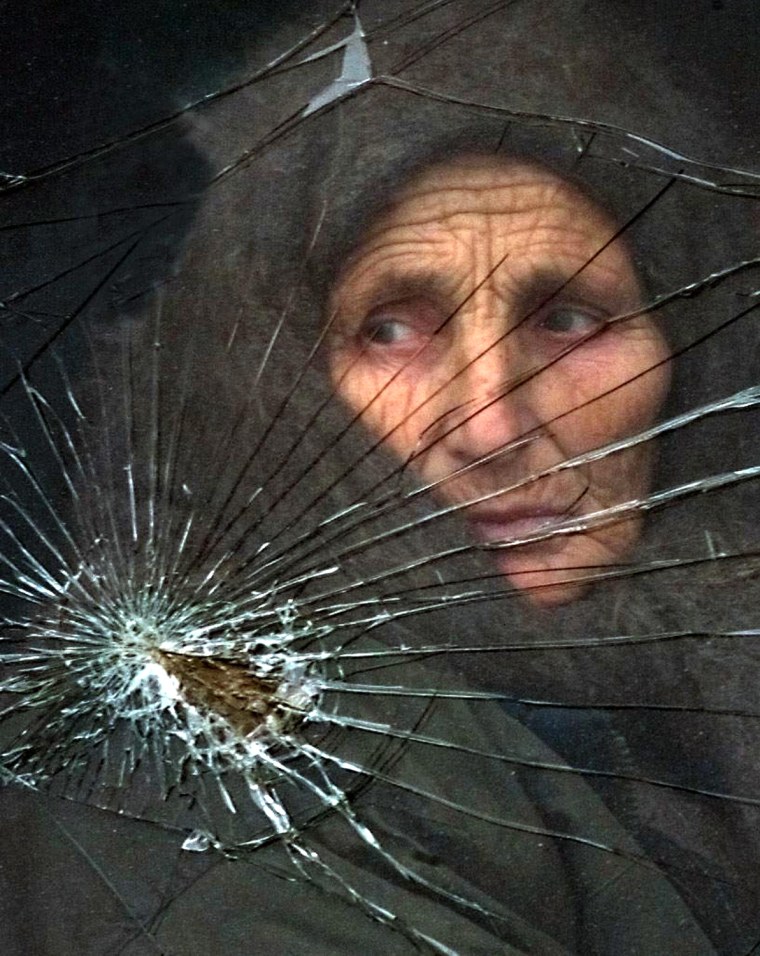 A Chechen woman from Grozny looks through the bus