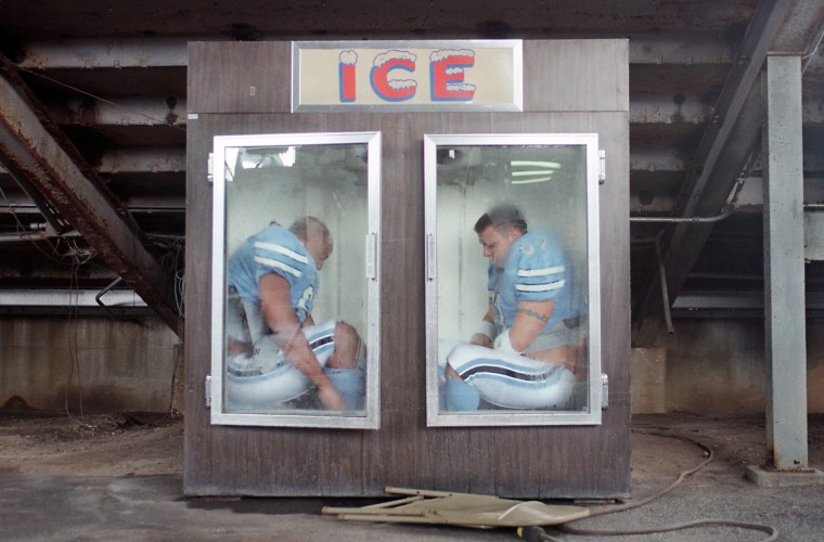 Citadel football players Corey White, left, and Aaron Capps try to keep cool while getting dressed for media day at Johnson Hagood Stadium Sunday. (August 13, 2000)  (Photo/Alan Hawes/The Post and Courier)