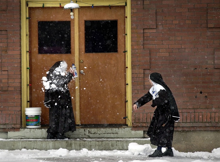 Sister Amanda de Jesus, left, is hit with a snowball thrown by Sister Rosa Elena after school Wednesday afternoon, Jan. 22, 2003, at Mount Saint Michael in Spokane, Wash. The two nuns, visiting from Mexico, said this was the first time they saw snow.(AP Photo/The Spokesman-Review, Brian Plonka)