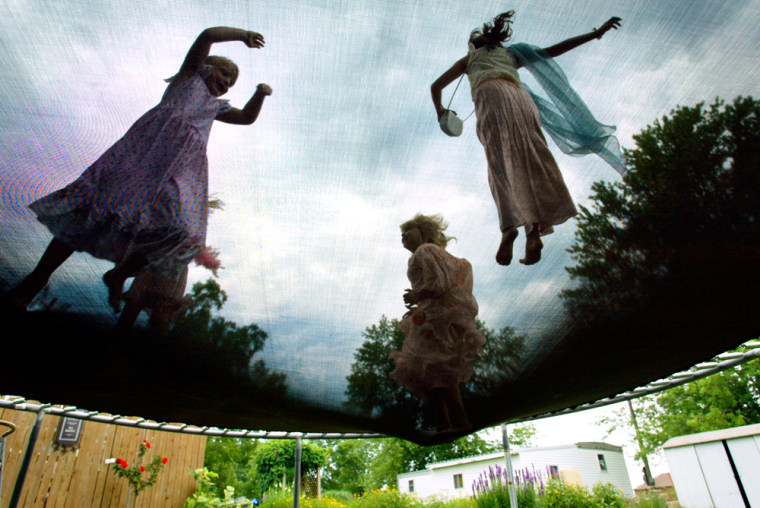Part of the ten-girl tea party enjoy jumping on the trampoline before tea time Saturday July 9, 2005 in Donnellson, Iowa. This annual tea party is put on by Judy Felt in her princess friendly back yard.
(AP Photo, The Hawk Eye, Courtney Hergesheimer)