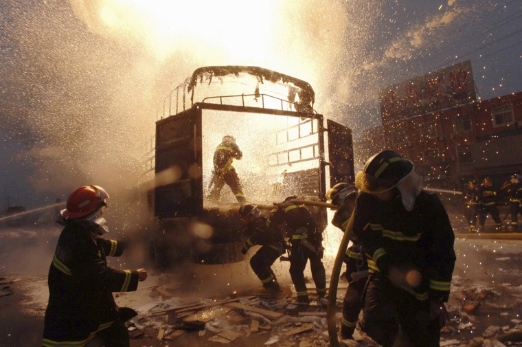 Firefighters try to extinguish a fire caused by the blast of aluminium powders in Wuxi