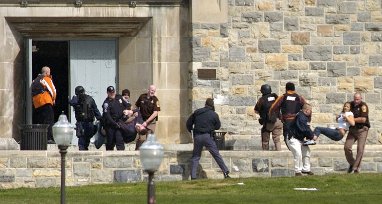Injured occupants are carried out of Norris Hall at Virginia Tech in Blacksburg, Va., Monday, April 16, 2007. A gunman opened fire in a dorm and classroom on the campus, killing at least 30 people in the deadliest shooting rampage in U.S. history. The gunman is killed but it's unclear if he was shot by police or took his own life. (AP Photo/The Roanoke Times, Alan Kim)
