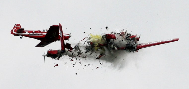 Two acrobatic planes from the Zelazny group collide during a performance at an air show in Radom, Poland, Saturday, Sept. 1, 2007. Both pilots died in the crash, but there were no reports of injuries in the crowd. (AP Photo/ Darek Redos)   ** POLAND OUT **