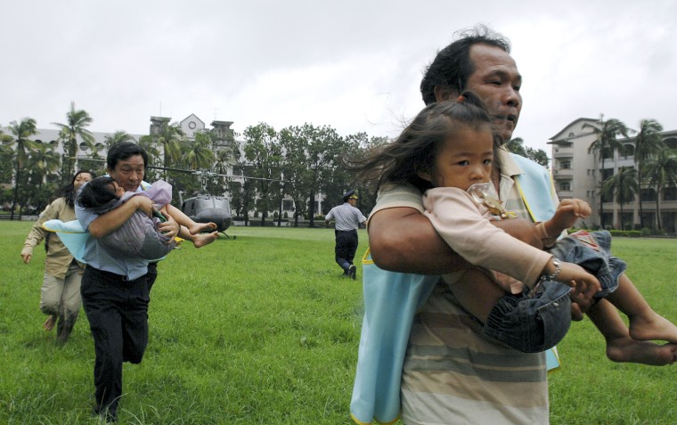 Image: Medical personnel evacuate children by a military helicopter from a landslide affected village after Typhoon Morakot swept Taiwan