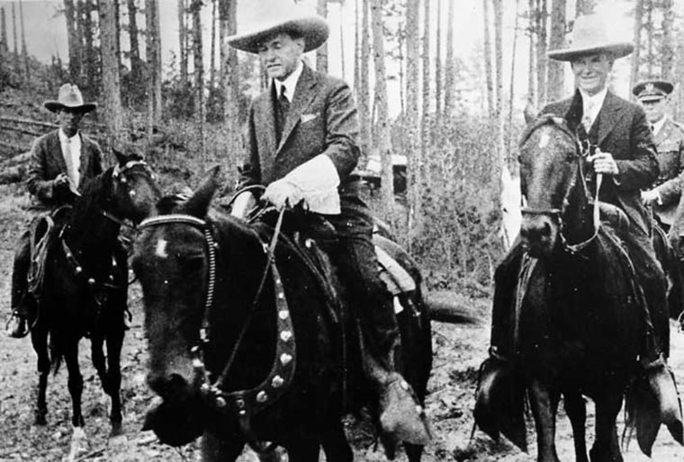 Calvin Coolidge rides a horse to the dedication ceremony of the Mount Rushmore National Memorial in South Dakota, Aug. 15, 1927.