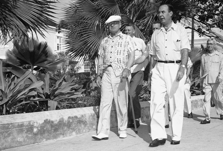President Harry Truman, spending his vacation at the naval base in Key West, Fla., on Nov. 30, 1949, wears one of his signature caps and sporty shirt as he carries a walking stick on a stroll about the station. (AP Photo)