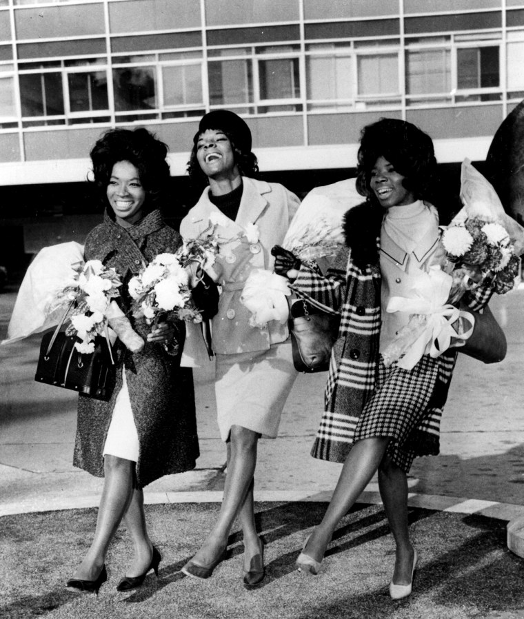 American pop trio Martha Reeves and the Vandellas are staging a dance at London Airport on November 3, 1964, as they arrive for TV appearances and recording work in the British capital. Seen from left are: Betty Kelly, Martha Reeves, and Rosalind Ashford. (AP Photo)