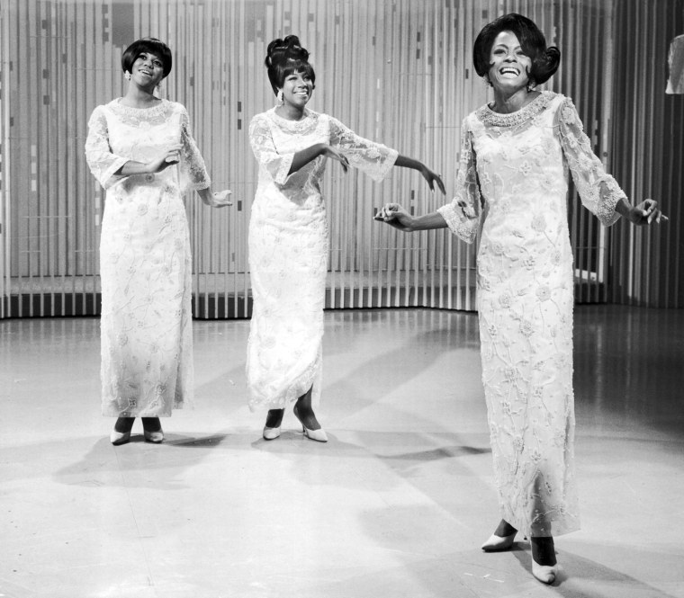 Full-length view of the pop singing group The Supremes (L-R; Mary Wilson, Cindy Birdsong, and Diana Ross) performing on a stage.  (Photo by Hulton Archive/Getty Images)
