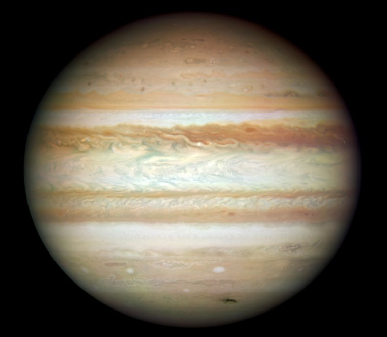 This Hubble picture, taken on July 23, is the first full-disk natural-color image of Jupiter made with Hubble's new camera, the Wide Field Camera 3 (WFC3). It is the sharpest visible-light picture of Jupiter since the New Horizons spacecraft flew by that planet in 2007. Each pixel in this high-resolution image spans about 74 miles (119 km) in Jupiter's atmosphere. Jupiter was more than 370 million miles (600 million km) from Earth when the images were taken.
The dark smudge at bottom right is debris from a comet or asteroid that plunged into Jupiter's atmosphere and disintegrated.
In addition to the fresh impact, the image reveals a spectacular variety of shapes in the swirling atmosphere of Jupiter. The planet is wrapped in bands of yellow, brown, and white clouds. These bands are produced by the atmosphere flowing in different directions at various latitudes. When these opposing flows interact, turbulence appears.