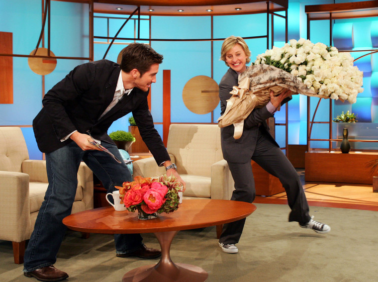 Image: Actor Gyllenhaal presents talk show host DeGeneres with roses during a taping of \"The Ellen DeGeneres Show\" in Burbank California