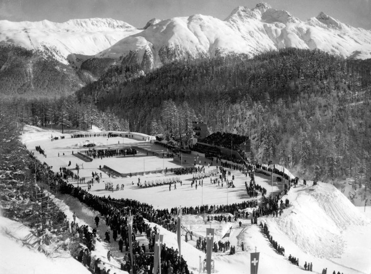 The American contingent of athletes (center, in while coats) into an outdoor stadium during the opening ceremonies of the 1948 Winter Olympics at St. Moritz, Switzerland, January 30, 1948. (Photo by FPG/Getty Images)