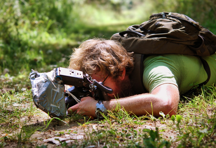 Here's a photo of the photographer Thomas Shahan getting a shot of a robberfly in August 2009.
