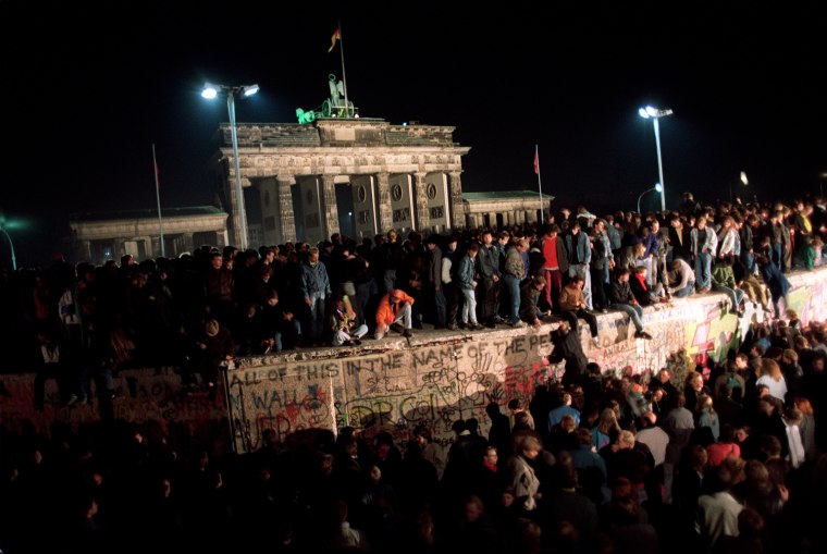 Thousands of young East Berliners crowd atop the B