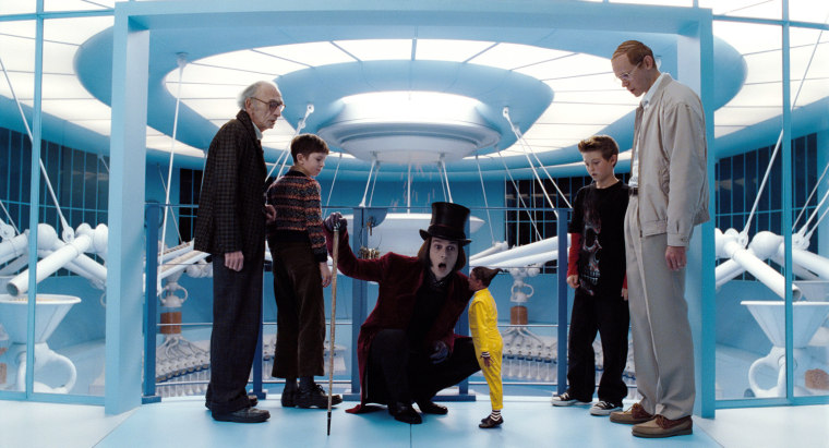 Charlie and the Chocolate Factory (2005)
Directed by Tim Burton
Shown: L-R: DAVID KELLY (as Grandpa Joe); FREDDIE HIGHMORE (as Charlie Bucket); JOHNNY DEPP (as Willy Wonka); DEEP ROY (as the Oompa-Loompa); JORDAN FRY (as Mike Teavee) and ADAM GODLEY (as Mr. Teavee)
Photo courtesy of Warner Bros. Pictures