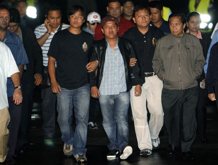 Image: Agents of the National Bureau of Investigation escort Ampatuan Jr in Pasay city, metro Manila