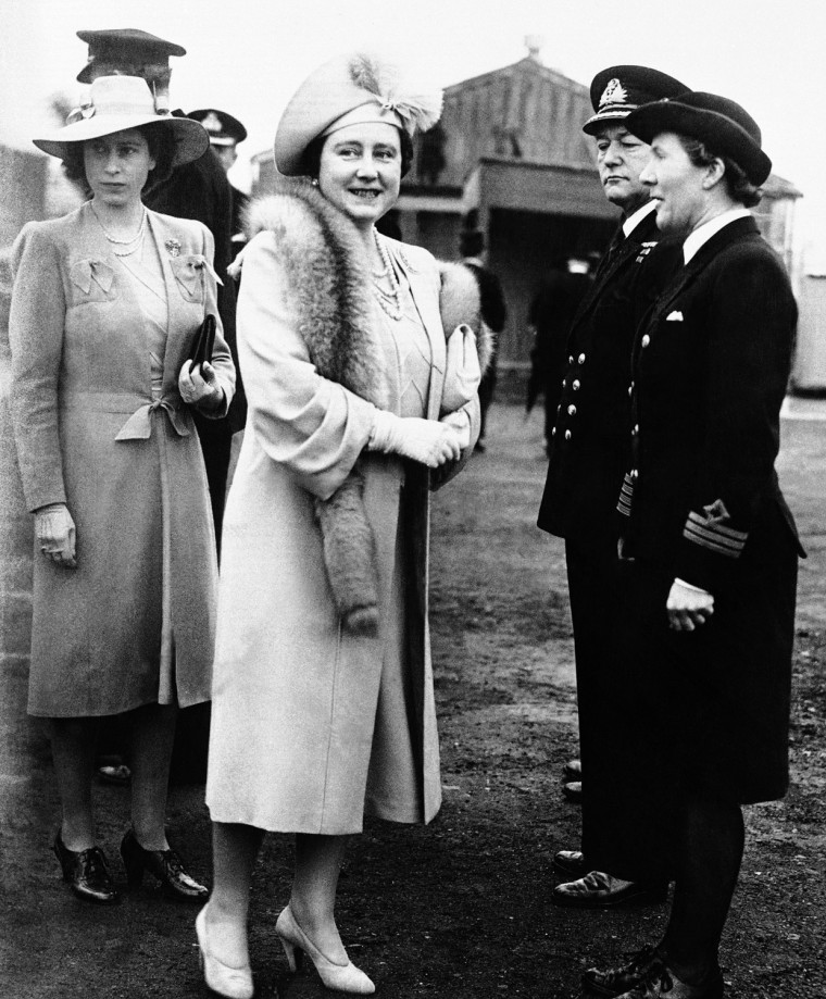 The Queen (center) and Princess Elizabeth (left), of England, talk to Wren Chief Officer E. King at the shipyards in Belfast in 1945, during a visit to Northern Ireland when King George opened Ireland?s New Parliament. (AP Photo)