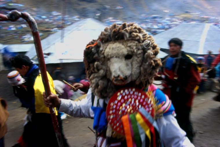 Dances at Qoyllur Rit'i are tied to ancient agricultural and pastoral rituals that date to the Incas and other pre-Columbian cultures. Above, a masked celebrant dressed as a sheep climbs to the glacier to play in the snow and ice.
