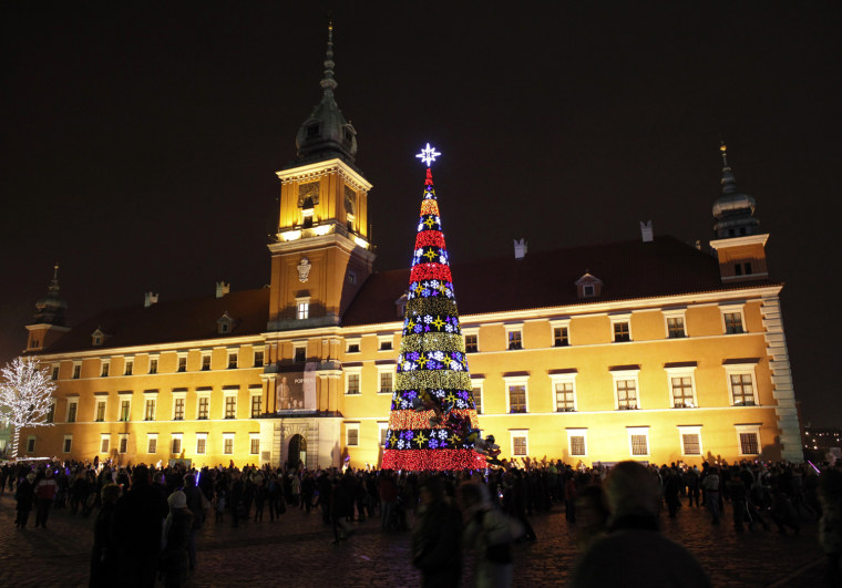Image: People attend the annual Christmas lighting ceremony in front of the Royal Castle in Warsaw