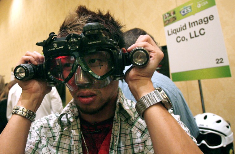Image: Guest wears a Liquid Image Scuba Series HD320 during a media preview for the 2010 International CES in Las Vegas