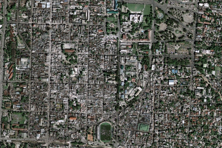 Satellite imagery captured on Wednesday, the day 
after Haiti's earthquake, shows the ruined National Palace surrounded by people 
and debris. Click on the image to explore the scene with HDView (plug-in required)