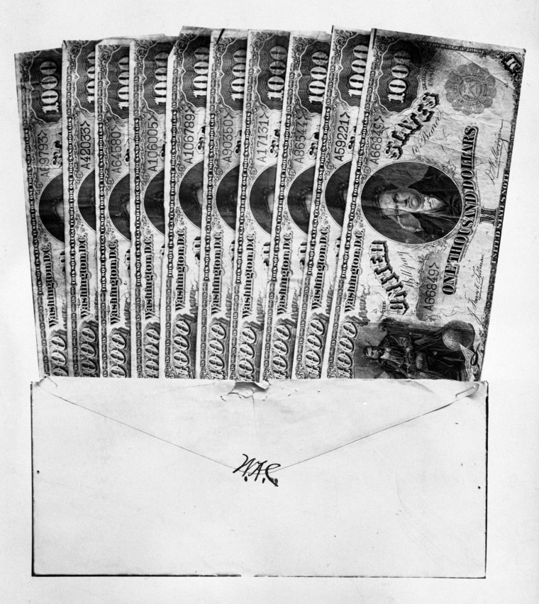 Thousand dollar bills in an envelope bearing the initials \"W.A.C.,\" supposedly used to bribe Montana legislators to send William Andrews Clark to the U.S. Senate in 1899. Not for re-use without permission of the Montana Historical Society.