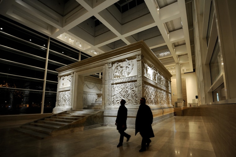 Image: People walk by the Ara Pacis on November
