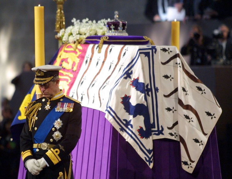Image: Prince Charles stands vigil beside the Queen Mothe