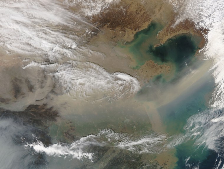 Image: An Aqua satellite image provided by NASA of a large dust storm sweeping across eastern China