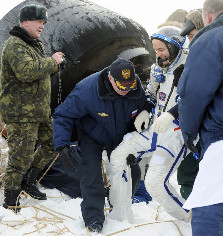 Image: Expedition 22 U.S. Commander Williams is assisted after the landing of the Russian Soyuz TMA-16 space capsule near the town of Arkalyk, in northern Kazakhstan