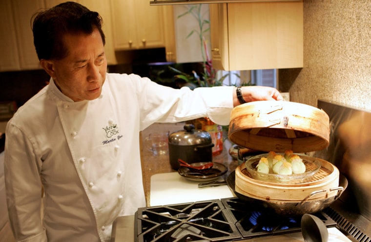 **FOR USE WITH AP LIFESTYLES**   Chef Martin Yan checks on a shrimp mousse tulip appetizer at his home in Hillsborough, Calif., Thursday, Jan. 24, 2008.  Now in his 30th year on television, Yan is still cooking, and spreading the message of honest food cooked fresh the Asian way.   (AP Photo/Jeff Chiu)