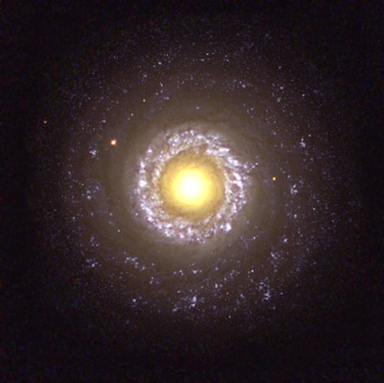 Sunny side up
The small spiral galaxy NGC 7742 is probably powered by a black hole residing in its core. The core of NGC 7742 is the large yellow \"yolk\" in the center of this fried-egg image.