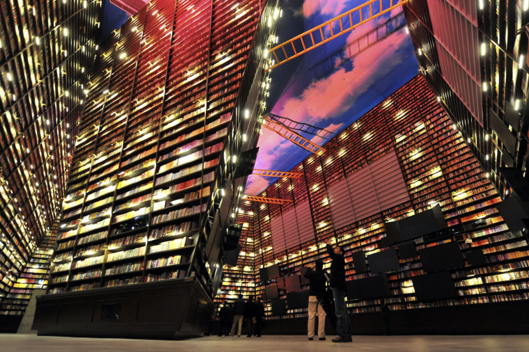 Image: Employees take pictures inside the Theme Pavilion of Shanghai World Expo 2010 in Shanghai