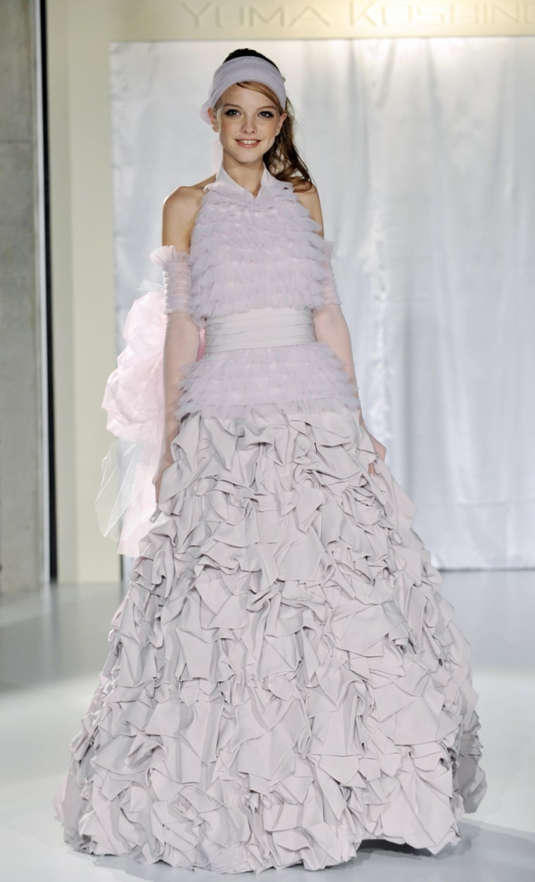 A model displays a wedding dress with cr