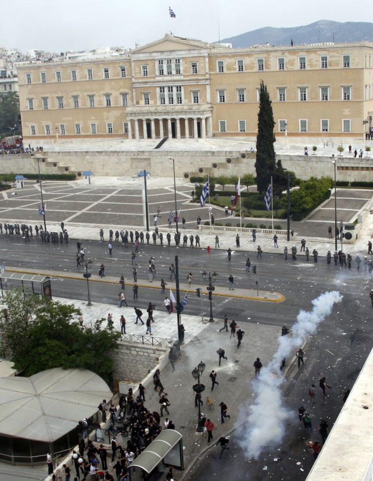 Image: Demonstrators run from teargas near the Greek parliament during nationwide strike over austerity measures in Athens