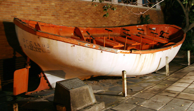 Lifeboat No. 5, salvaged, now part of an exhibit at the East London Museum in South Africa. 
The plaque to the left says: \"Lifeboat number 5 from the ill-fated Oceanos was presented by the east London survivors to commemorate one of the most remarkable rescue operations of the twentieth century. In gale-force winds and heavy seas all 571 aboard were saved before the Oceanos sank off the Transkei coast on 4 August 1991. 40 survivors spent the night in this open lifeboat before being rescued by Kaszuby 11.