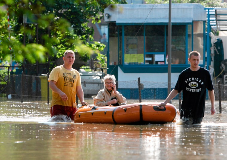 Image: A woman is evacuated from flooded Kozanow district of Wroclaw by the Sleza river in Wroclaw